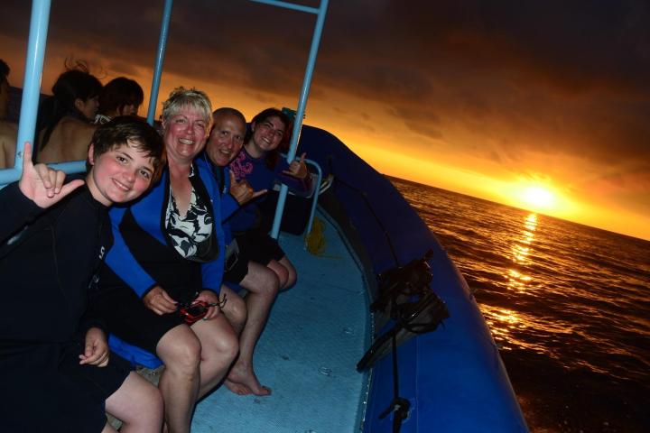 a group of people on a beach posing for the camera