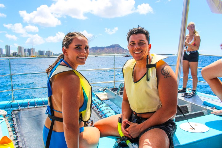 a group of people standing on a beach