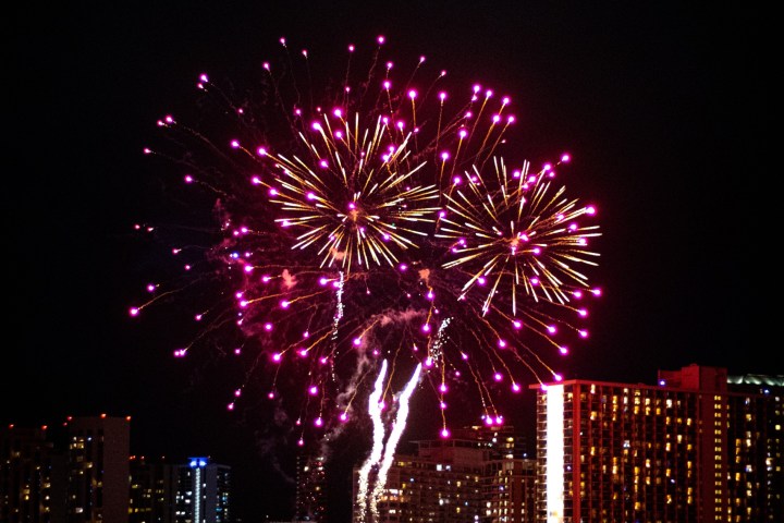 fireworks in the night sky over a body of water