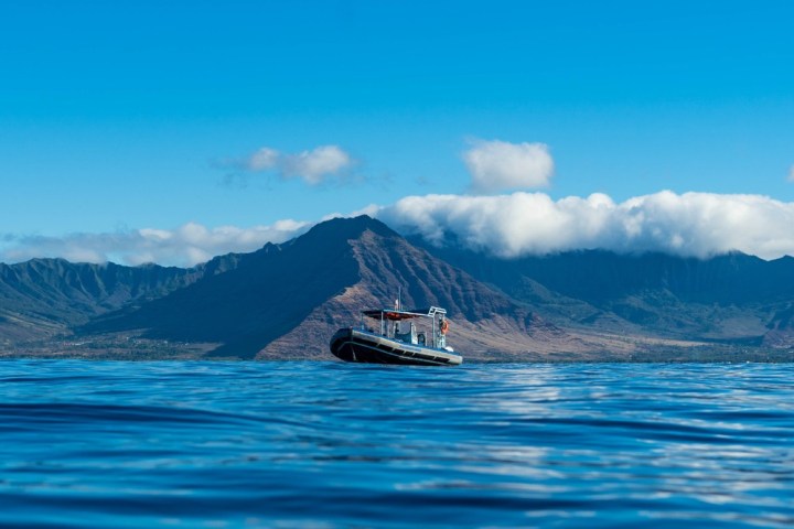 a body of water with a mountain in the background