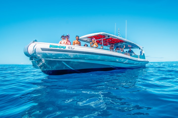a large blue boat sitting next to a body of water