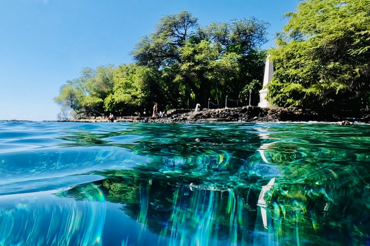 a large waterfall over a body of water