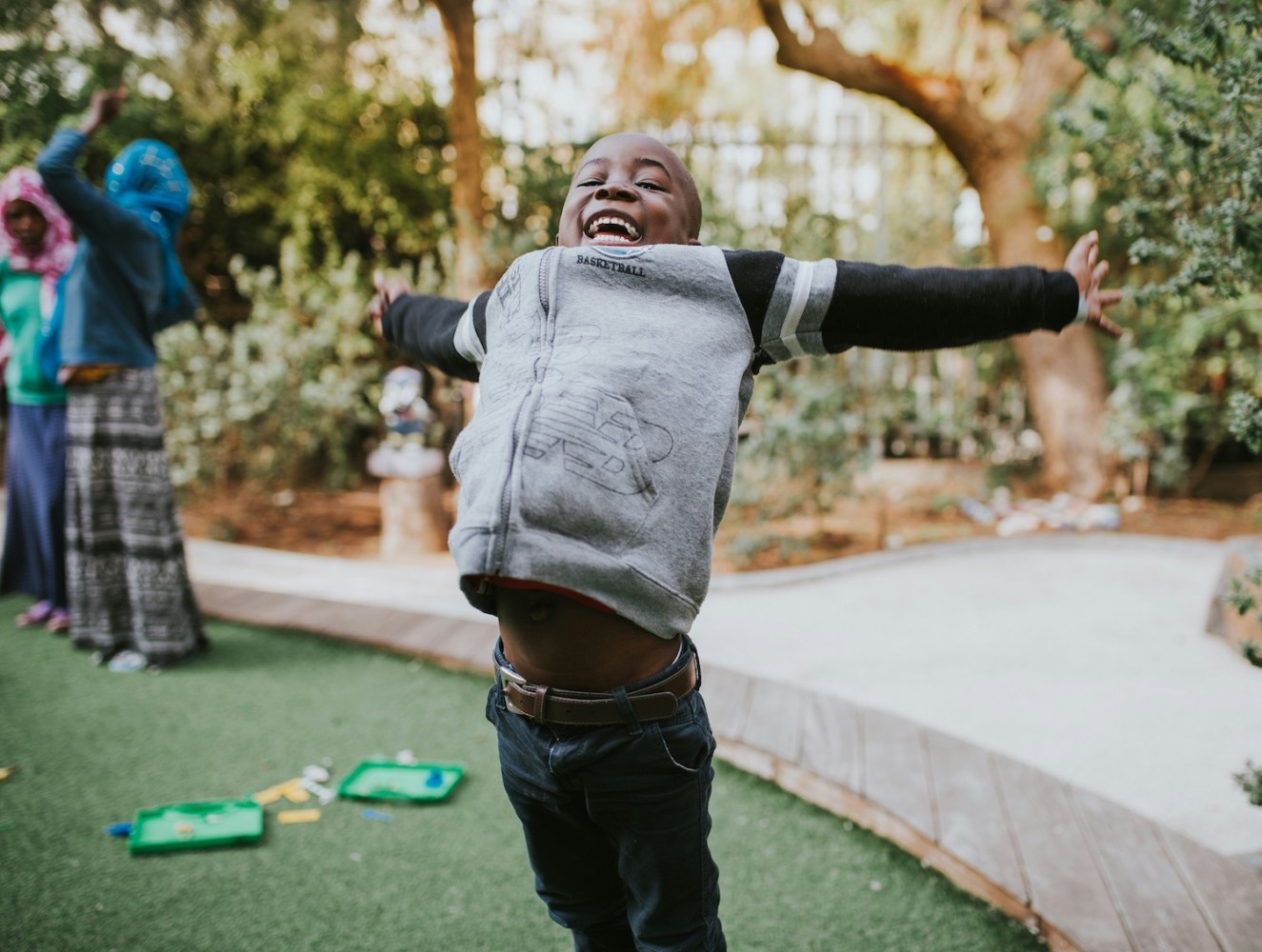 a little boy celebrates while playing mini golf