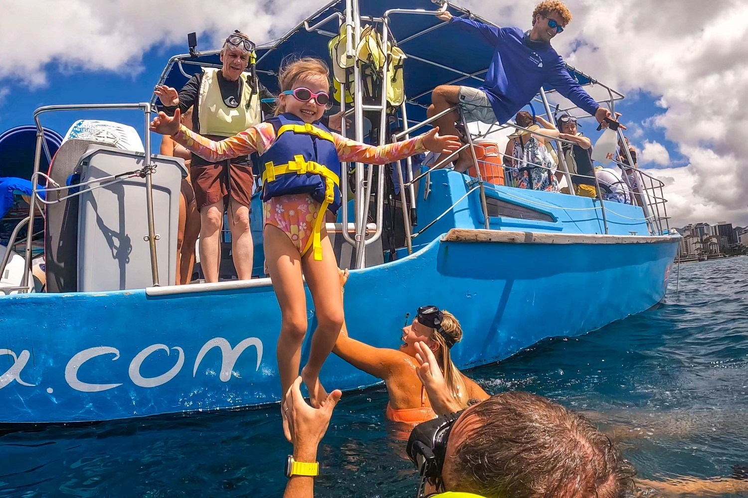 a girl jumping out of a boat