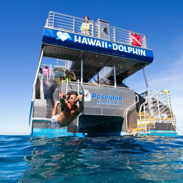 a man riding on the back of a boat in the water